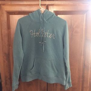 Light blue hollister hoodie w/ white cursive logo